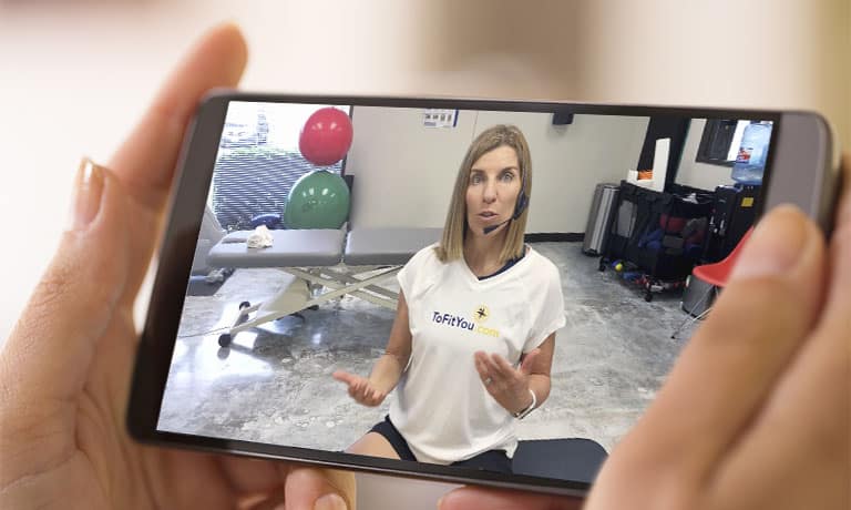 Female hand holding a smart phone during a Skype video